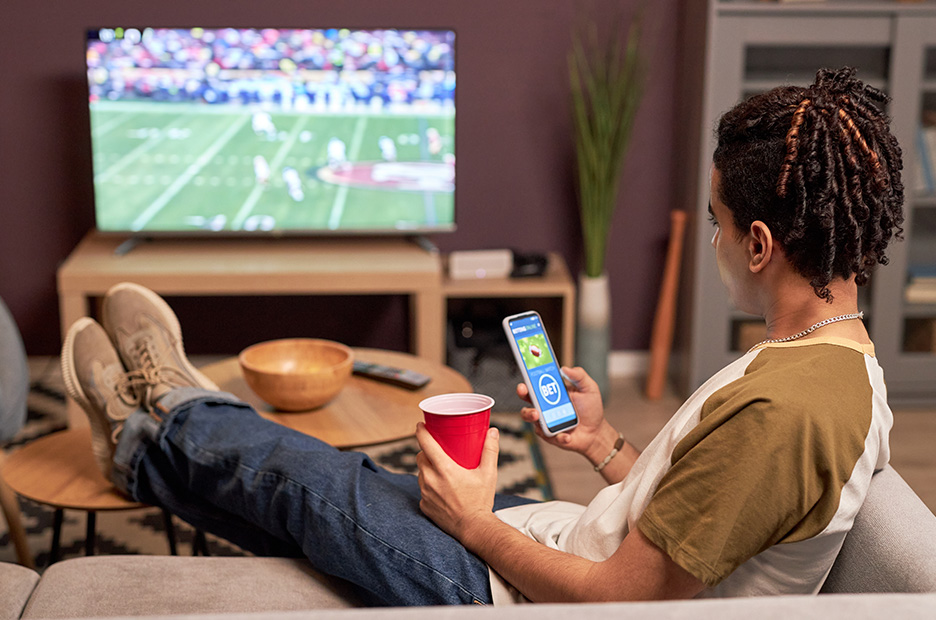 A picture of a person deciding for which team to bet on
